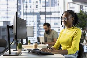 Computer scientist fixing applications issues, dealing with databases and server configuration. African american woman optimizing company software for improved performance and scalability photo