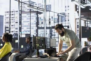 Admin using laptop to manage cloud computing resources and platforms to train and deploy large scale machine learning models. Worker monitoring and maintaining company systems using notebook photo