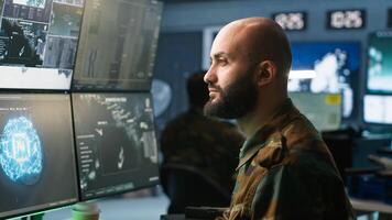 Army computer scientist employing AI technology in military planning and decision making processes. Expert uses artificial intelligence to enhance armed forces operational capabilities, camera A photo