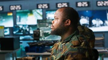 Officer doing tasks in military base, planning, analyzing and gathering information on enemy troops. Agent in base of operations doing assessment of enemy vulnerabilities, tracking, camera A photo