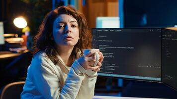 Portrait of engineer drinking coffee in the morning and futureproofing company network from downtimes. IT admin enjoying hot beverage while increasing data security, camera A photo