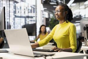 Programmer using laptop to fix applications issues, dealing with databases and server configuration. IT specialist using notebook, optimizing company software for improved performance and scalability photo