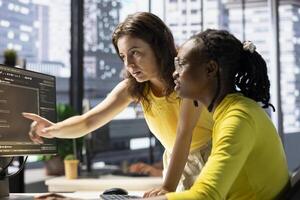 Manager correcting employee mistakes while conducting code review to fix bugs, identifying performance and technical issues with company software. Team leader supervising IT worker optimizing code photo