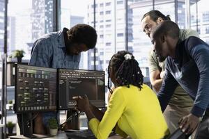 Teamworking colleagues testing machine learning company software to minimize occurrence of bugs, identifying bottlenecks. Coworkers doing brainstorming, writing clean, efficient code to reduce errors photo