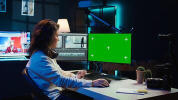 Woman using professional software on mockup PC to create visual effects for projects. Specialist using post production techniques to edit raw clips footage on green screen computer, camera B photo