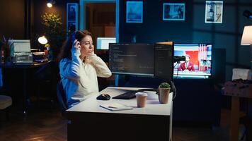 Freelancing programmer listening music while designing and developing software applications. IT specialist wearing headphones, implementing and maintaining company systems, camera B photo