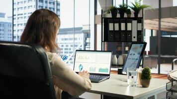 Female entrepreneur working on financial planning and budget allocation, ensuring the company resources are used effectively to achieve maximum profit and long term business objectives. Camera A. photo