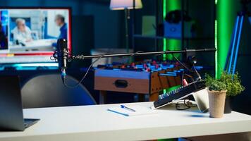 Empty home production studio with podcast equipment technology recording sound for streaming site entertainment show. Live broadcasting cozy location in living room with rgb lights photo