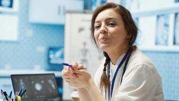 Physician meets with a patient to discuss medical results in a cabinet, using advanced diagnostic equipment to interpret x ray scans, demonstrating a professional healthcare approach. Camera A. photo