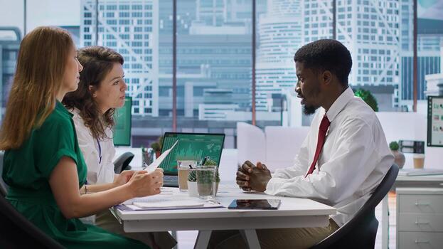 Recruitment team conducts an interview with a professional job applicant, evaluating their resume and discussing their background. HR employees addressing a series of questions. Camera A. photo
