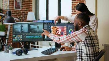 Diverse mixed race couple working as a team for a freelance shoot, editing and mixing clips in post production using modern software. Multiethnic people do remote work. Camera A. photo