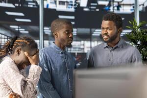 Black corporate team collaborates on global investment strategy, guided by a confident CEO with extensive expertise to work on data driven decisions. Solving administrative tasks in the office. photo