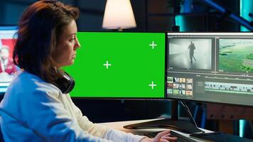 editor analyzing film montage on isolated screen display, editing color grading in office. Post production studio employee working with raw footage on chroma key PC, camera A photo
