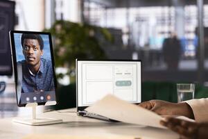Business manager using tablet to do videocall with CEO, attending briefing meeting, discussing paperwork. Close up of expert in teleconference call explaining startup evolution vision to manager photo
