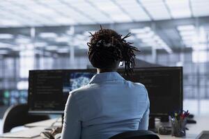 Programmer in data center using artificial intelligence computing simulating human brain thought processes in computerized model. Employee working with AI machine learning algorithms photo