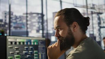 System administrator working with machine learning artificial intelligence critical to autonomous systems. Close up of man transforming data into predictive models, camera B photo