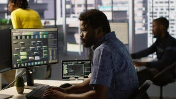 Computer scientist resuming work after strolling in workspace, doing software debugging using PC. Man walking with tablet in office, fixing coding issues using computer, camera A photo