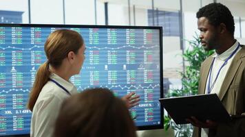 Business associates sharing ideas in a corporate briefing meeting, utilizing interactive boards to present detailed project reports and align on key performance indicators and objectives. Camera A. photo