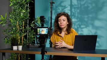 Content creator using professional camera to shoot intro for vlog channel on online platforms. Internet star warmly welcoming dedicated fanbase, recording with advanced gear, camera A photo