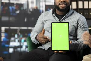 Supervisor using green screen tablet attends meeting to chat about new business vision with executive board members. Closeup of office clerk using mockup device to pitch investment strategy to manager photo