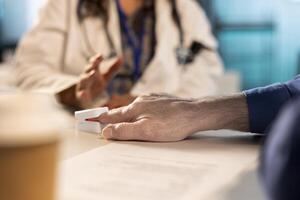 Health specialist takes the oxygen saturation measurement and checking vital signs during a routine check up with her old patient. Medic using an oximeter for accurate readings. Close up. photo