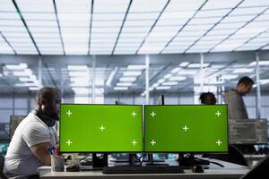 Multi monitor isolated screen computers in data center used by IT employees for supervising server rows in computer network security data center, overseeing supercomputers photo