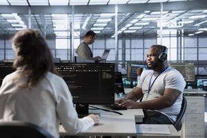Engineer in data center coordinating deployment of server architecture, improving data processing speed in client workload capacity. Server room expert configuring and testing hardware photo