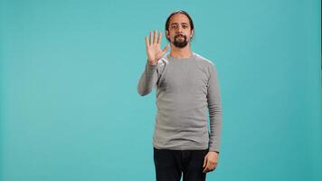 Man looking at AR hologram visualizations, doing swiping gestures. Technology enthusiast using futuristic modern augmented reality tech, isolated over studio background, camera A photo