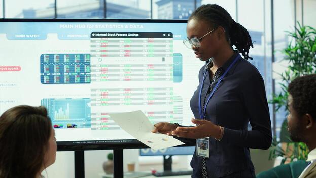 In a high end boardroom, employees gather to brainstorm ideas and create strategies, analyzing statistics to drive business development and ensure successful project. Enterprise solutions. Camera A. photo