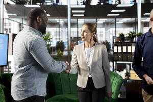 Interviewer holding meeting with job candidate, shaking hands, asking questions and presenting company background. Human resources employee interviewing man for open position photo