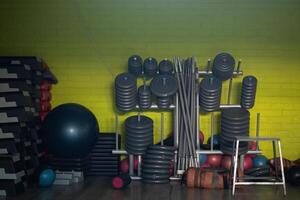 A pair of dumbbells neatly arranged in the gym, ready for a powerful workout session to build strength and endurance photo