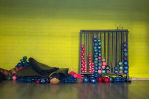 A pair of dumbbells neatly arranged in the gym, ready for a powerful workout session to build strength and endurance photo