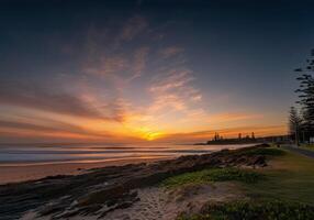 Sunset at the beach with a path leading to the ocean photo