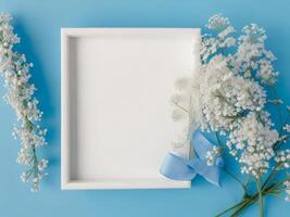 White flowers and a white frame on a blue background photo