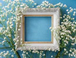 White flowers and frame on blue background photo