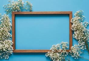 Frame with white flowers on blue background photo