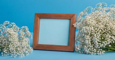 Photo frame with baby's breath flowers on blue background