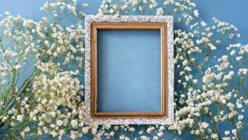 Frame with flowers on blue background photo