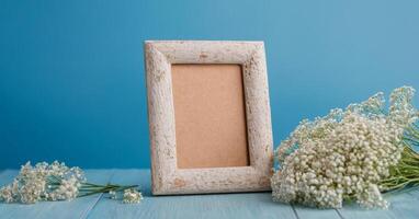 Photo frame with white flowers on blue background