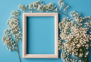 Frame with flowers on blue background photo