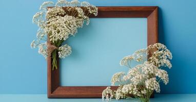 Frame with flowers on blue background photo