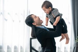 Mother plays joyfully with her toddler in a bright, modern living room during the afternoon photo