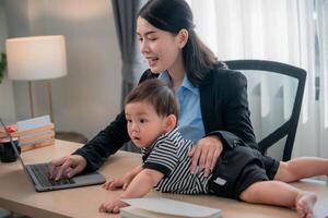Working mother engages with child while managing tasks in a home office setting photo