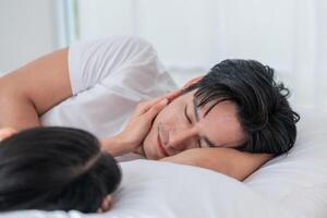 Couple sharing a tender moment in a cozy bedroom during a quiet morning photo