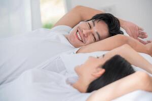 Couple enjoying a peaceful morning together in bed with soft natural light photo