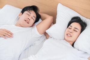 Couple resting peacefully on a bed in a bright and cozy bedroom setting during the morning hours photo