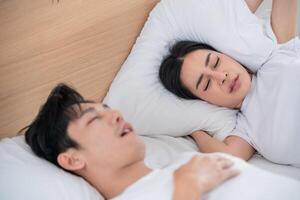 People sleeping peacefully in a cozy bedroom with soft pillows and a calming atmosphere early in the morning photo