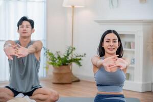 Yoga practitioners stretching in a bright modern studio during a morning class photo
