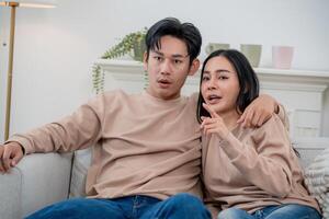 Couple enjoying relaxed time together on a sofa while engaged in an animated conversation photo