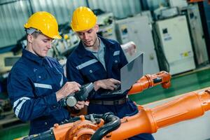Engineers conduct robotic system diagnostics in a manufacturing facility to enhance efficiency and performance photo